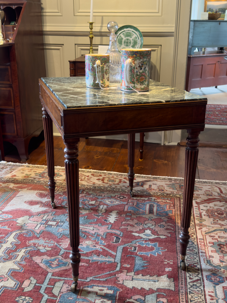 A Scarce And Elegant Sheraton Mahogany Mixing TableRetaining The Original Marble Top Above A Reeded Freize, Ending In Original Brass Caps - side view